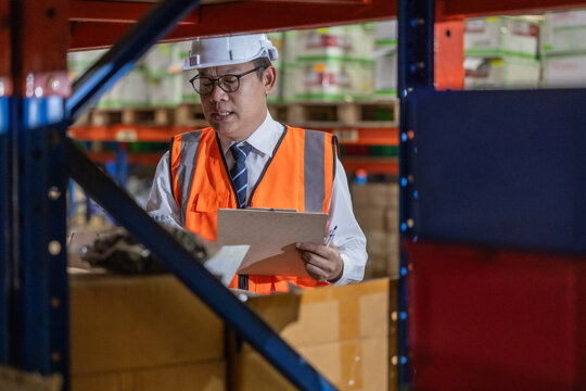 Warehouse manager process paperwork, organize goods by size, shape, category, prepare delivery date