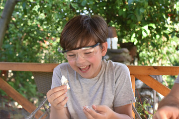 Happy child digging the dinosaur and having fun with archaeology excavation kit. Boy plays and learns, Dig the dinosaur from archeology kit