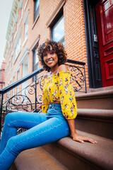Pretty african american woman wearing fashionable stylish clothing in New York - Portrait of pretty adult black female strolling in the city - obrazy, fototapety, plakaty