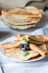 Breakfast: fresh pancakes with berries. On a wooden background. Morning