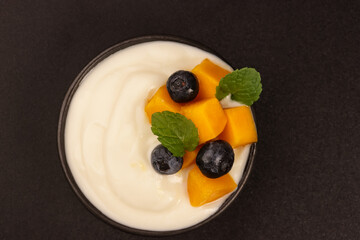 Milk Yogurt Topping with Mango and Blueberry. 