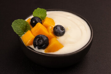 Milk Yogurt Topping with Mango and Blueberry. 