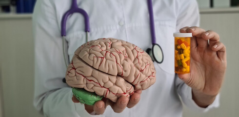 Doctor holds psycho neurological pills for brain in hands