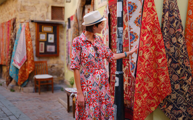female summer travel to Antalya, Turkey. young asian woman in red dress walk old town Kalechi ,...