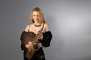 beautiful young woman playing the saxophone