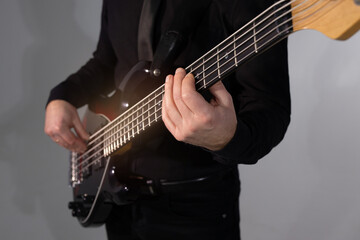 stylish electric guitar in the hands of a playing guitarist
