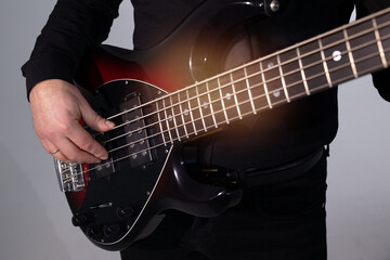 stylish electric guitar in the hands of a playing guitarist