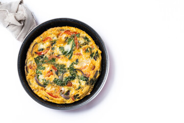 Italian Frittata made with spinach, tomatoes, onion and peppers isolated on white background. Top view. Copy space