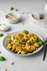 	
Fried Italian potato gnocchi with cheese and herbs on a white background. Italian food.