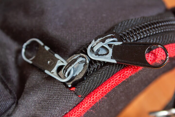 Metal zipper on a black bag, closeup photo