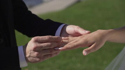 Groom puts wedding ring