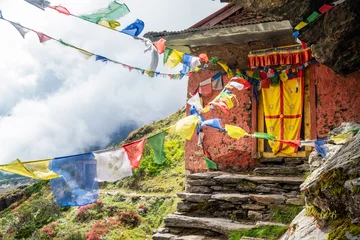 Papier Peint photo Makalu Small Buddhist monastery decorated with multicolored Tibetan prayer flags with mantras on Kothe - Thangnak climbing Mera peak route in Makalu Barun National Park. Peaceful and sacred place photo.