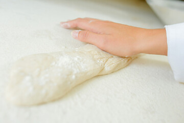 close up of hands roll that dough