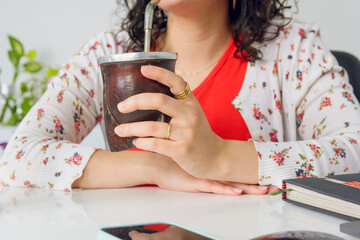 closeup of unrecognizable young woman with mate in her hand at work office