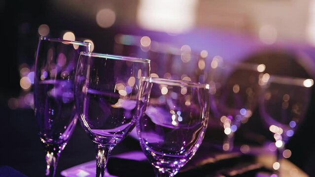 A close-up of the glasses that stand on the festive table in the local light.