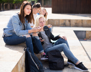 Teenagers communicate with each other in the schoolyard