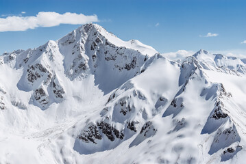 Snowy mountains. Beautiful landscape with snowy rocks. View from the top of Mount Elbrus - 696334422