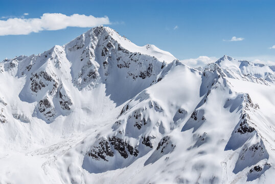 Snowy mountains. Beautiful landscape with snowy rocks. View from the top of Mount Elbrus