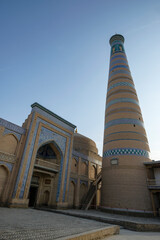 View of the minaret of the Islam Khodja madrasa in the old town of Khiva, Uzbekistan.