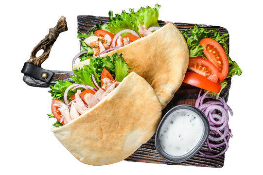Greek gyros wrapped in pita breads with vegetables and sauce.  Transparent background. Isolated.
