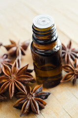 Small bottle with star anise oil. Aromatherapy end herbal medicine concept.
