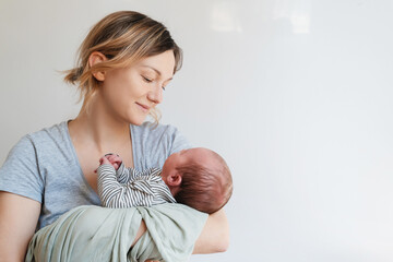 Mother and baby at home. Happy maternity and family. - 696344873