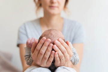 Newborn head in mother hands. Mother and baby