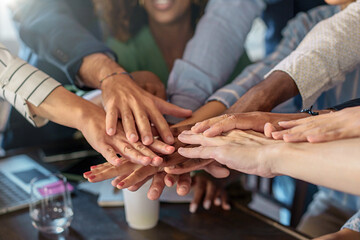 Unified Hands of a Business Team - concept of teamwork empowerment and collaboration in multiethnic workplace - obrazy, fototapety, plakaty