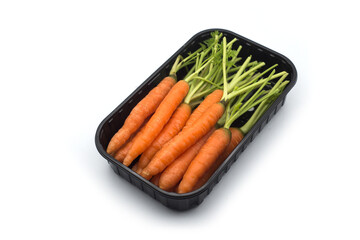 group on mini carrots in a plastic tray on white background