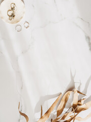 Minimal fashion frame with feminine accessories on a white marble dressing table with shadow