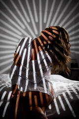 Slender girl in lingerie with shadows on her body - 696352601