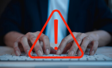 businessman typing on keyboard in concept of emergency warning alert sign on internet network...