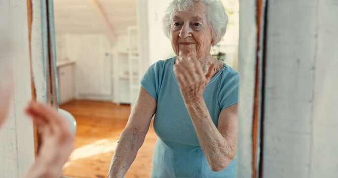 Mirror, skincare, morning and senior woman in bathroom of old age home for retirement wellness. Smile, reflection and relax with happy elderly person or pensioner getting ready in apartment routine