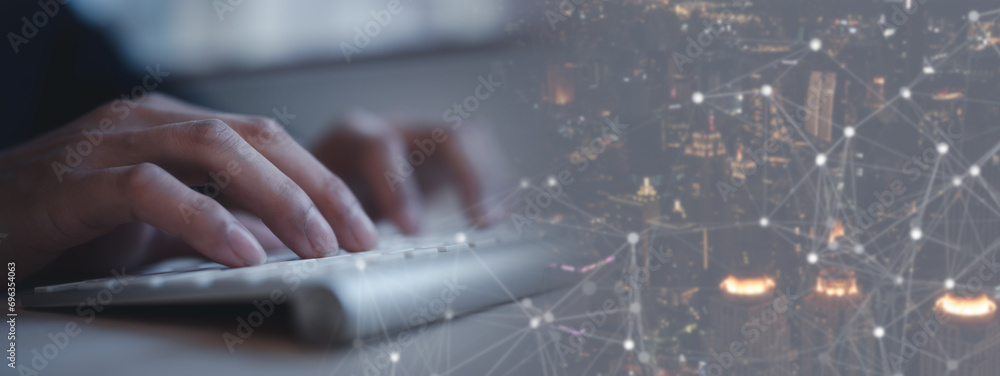Poster businessman typing on computer keyboard and blurred city background in smart city and communication 