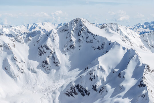 Snow-covered winter mountains of the Caucasus on a sunny day. Panoramic view from the ski slope of Elbrus, Kabardino-Balkaria, Russia