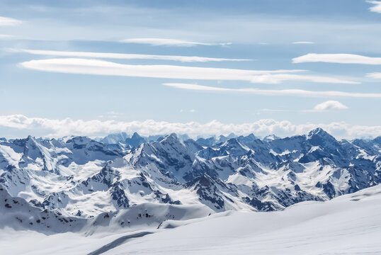 Snow-covered winter mountains of the Caucasus on a sunny day. Panoramic view from the ski slope of Elbrus, Kabardino-Balkaria, Russia