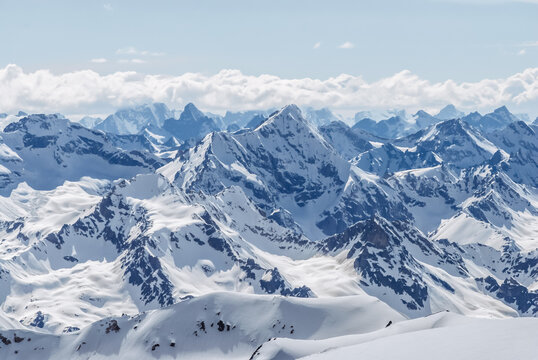 Snow-covered winter mountains of the Caucasus on a sunny day. Panoramic view from the ski slope of Elbrus, Kabardino-Balkaria, Russia