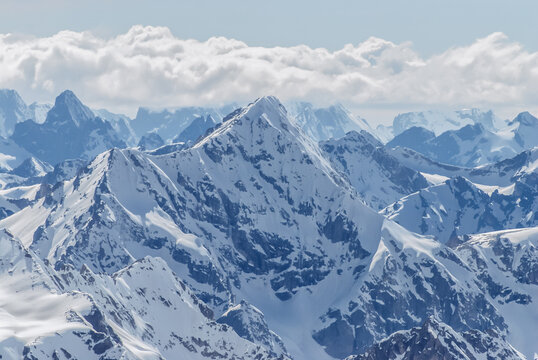 Snow-covered winter mountains of the Caucasus on a sunny day. Panoramic view from the ski slope of Elbrus, Kabardino-Balkaria, Russia