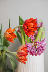 Red bouquet of tulips in a vase. Spring background with a bouquet of flowers. Front view