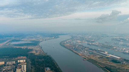 Antwerp, Belgium. River Scheldt (Escaut) port infrastructure with docks and factories. Morning...