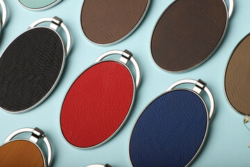 Metal and leather keychains. Colorful one side leather; Square, rectangle and circle shaped key rings. Concept shots, photos taken specially for e-commerce sales.