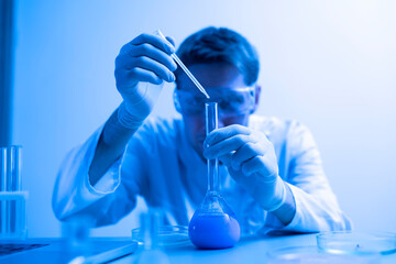 male scientist in white uniform working on a research in a laboratory