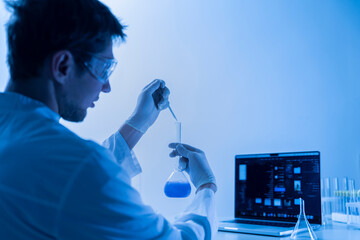 male scientist in white uniform working on a research in a laboratory
