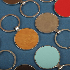 Metal and leather keychains. Colorful one side leather; Square, rectangle and circle shaped key rings. Concept shots, photos taken specially for e-commerce sales.