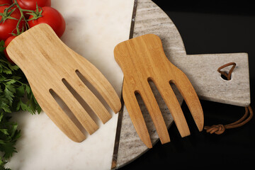 Wooden salad hands, bamboo kitchen utensils, bamboo salad hands, wooden salad spoons, close-up and concept shot. e-commerce photos, free space for writing,