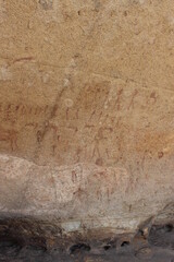 Ancient cave paintings in Africa with people and animals

