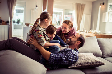 Happy family having fun on the couch at home