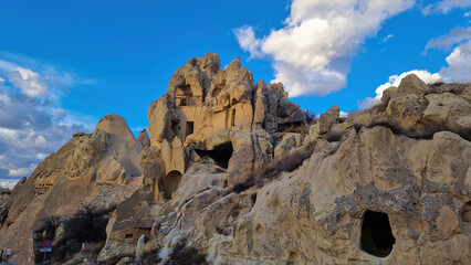 Fototapeta premium Caves Carved into Cappadocia's Timeless Rock Landscape.