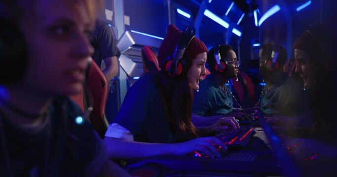 Professional female gaming team winning match at tournament arena