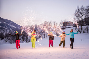 Group of snowboarders on winter holiday season having fun and bonding outdoors in the snow